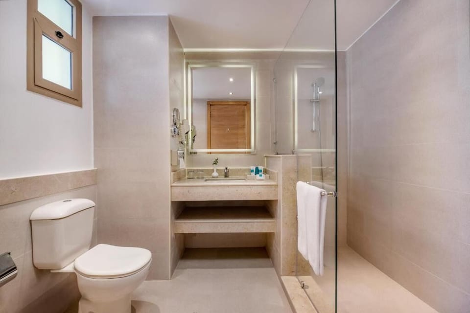 Refresh in a sleek, glass-walled shower after beach days.