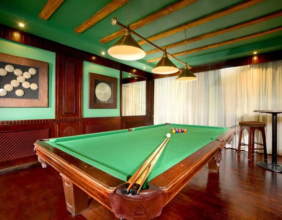 Challenge friends to billiards in a cozy, classic game room.