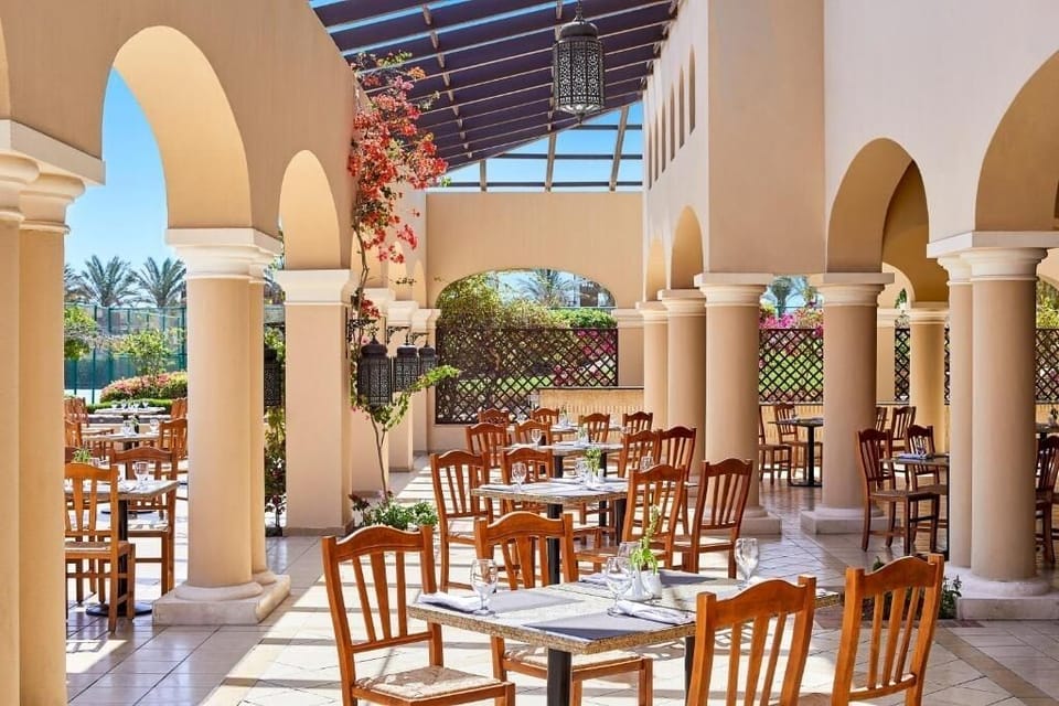 Dine leisurely under arches with warm shade and breezes.