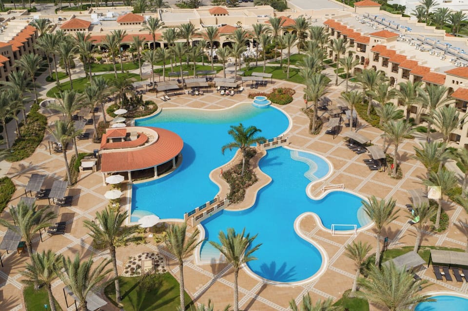 Dive into lagoon-style pools surrounded by swaying palms.