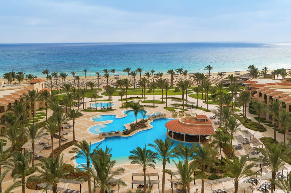 Soak up sunshine with panoramic sea views beyond the pool.