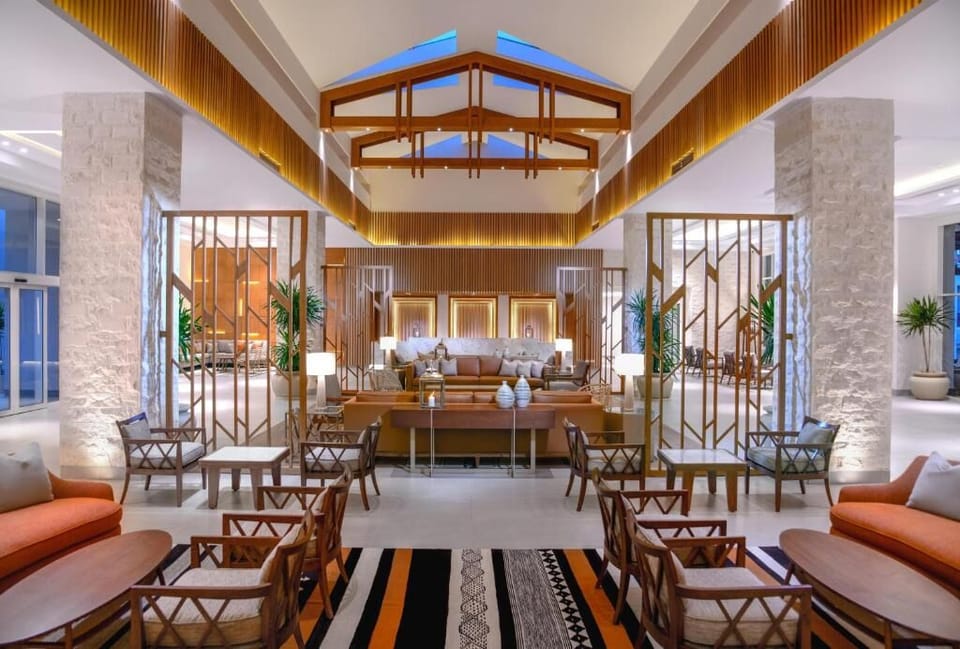 Unwind in the airy lobby with warm, designer seating.