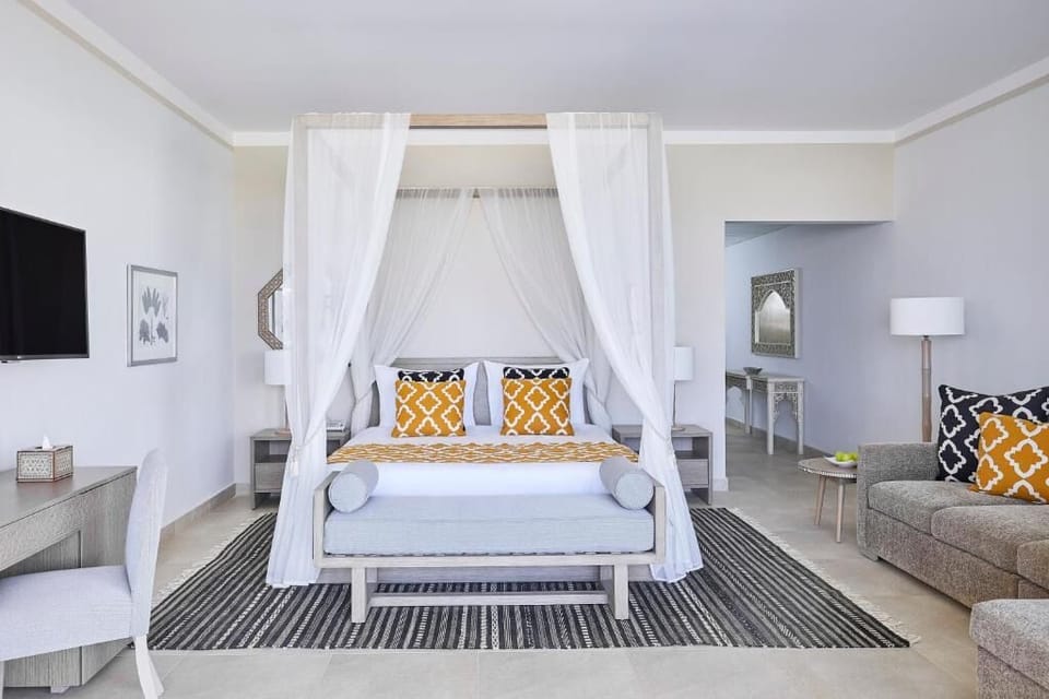 Sink into crisp linens beneath a romantic canopy bed.