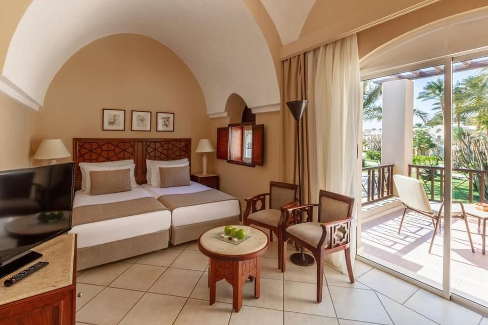 Settle into crisp twin beds under elegant arched ceilings.