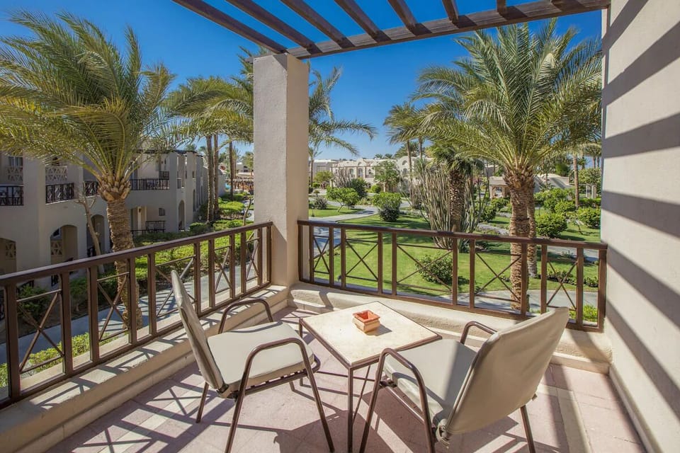 Sip morning coffee on the sunny terrace overlooking palms.