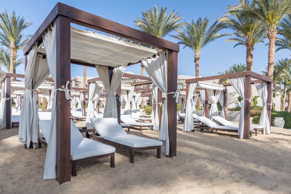 Lounge in private beach cabanas with breezy ocean air.