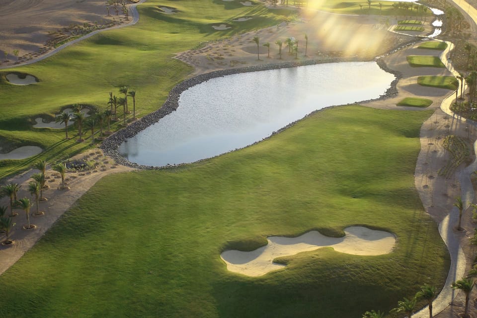 Stroll along tranquil greens and shimmering lake views.