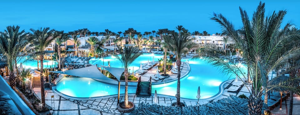 Dive into glowing lagoon pools under dreamy evening skies.