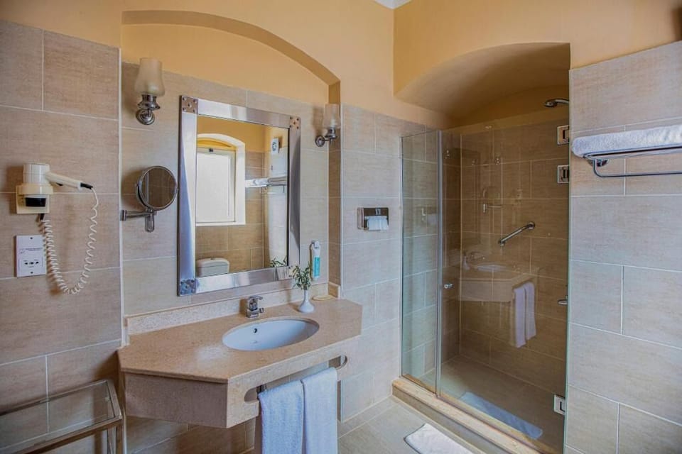 Refresh in a spotless bath with walk-in glass shower.