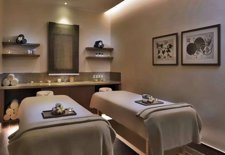 Sink into a soothing couples massage in candlelit calm.