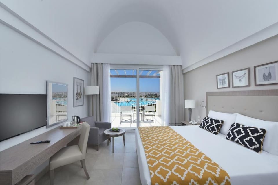 Stretch out on a king bed facing bright balcony views.