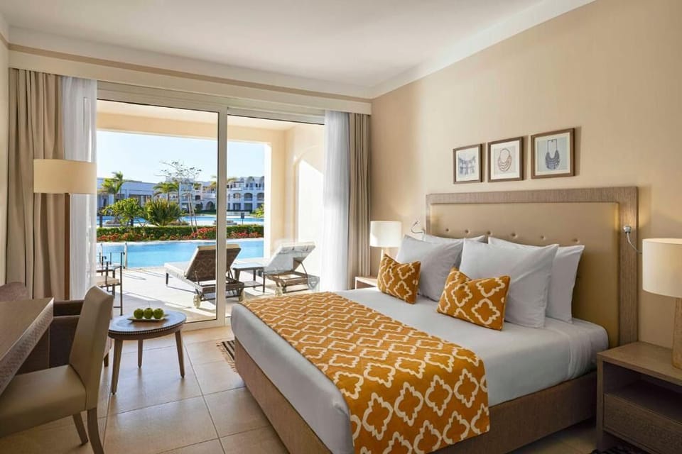 Unwind in a sunlit bedroom with direct poolside terrace access