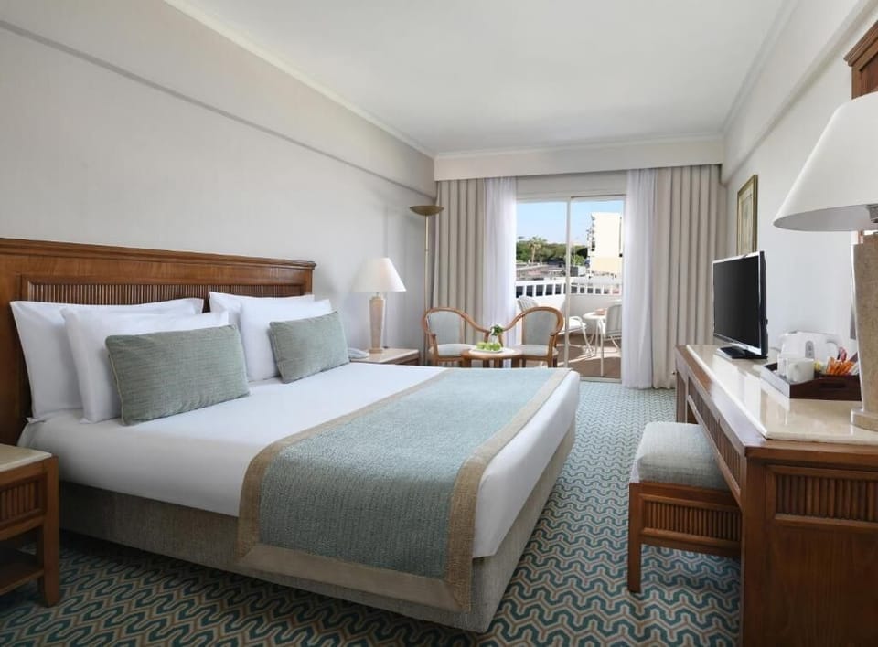 Unwind on the plush king bed with balcony breezes.
