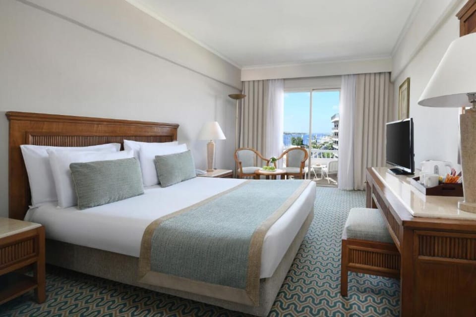 Relax in bright twin beds with garden-facing balcony doors.