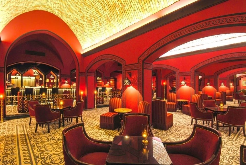 Sip crafted cocktails in a stylish bar with soaring arches.