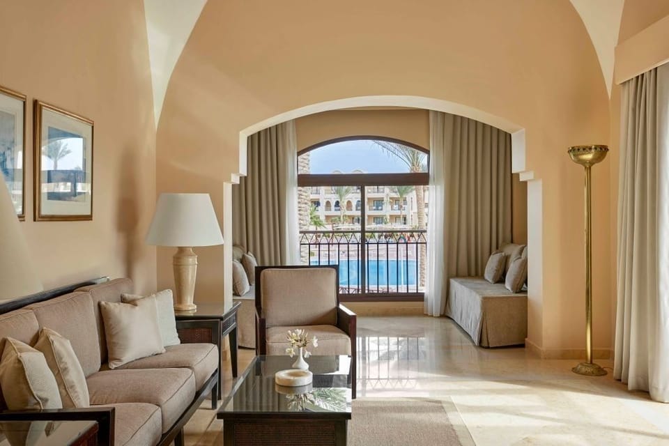 Relax in a bright lounge with resort views through arched windows.
