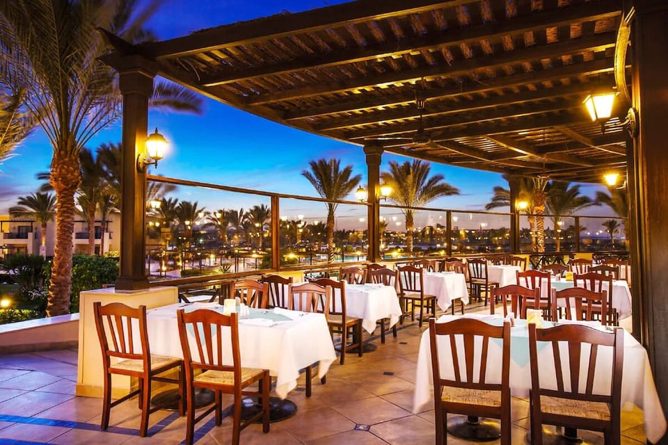 Dine under warm lights as the resort glows at night.
