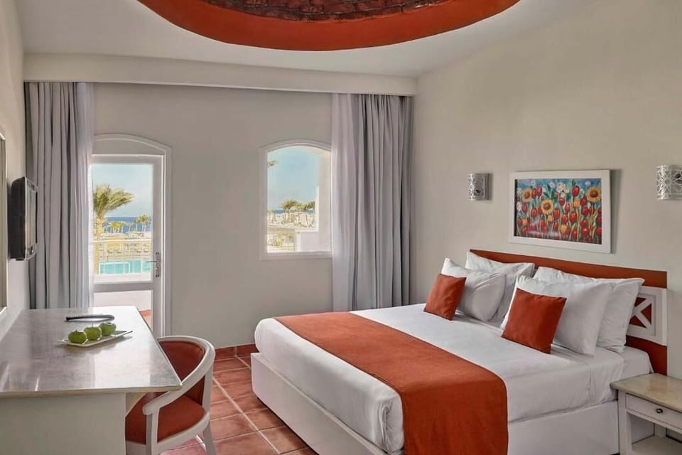 Unwind in crisp linens with a peek of sea.