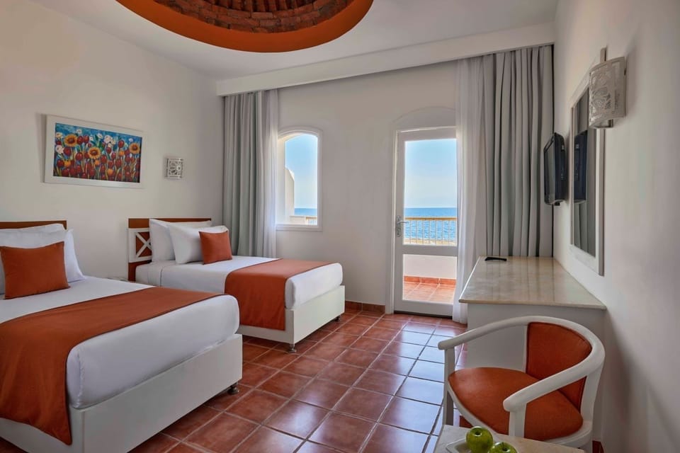 Drift off in twin comfort with sparkling sea beyond.
