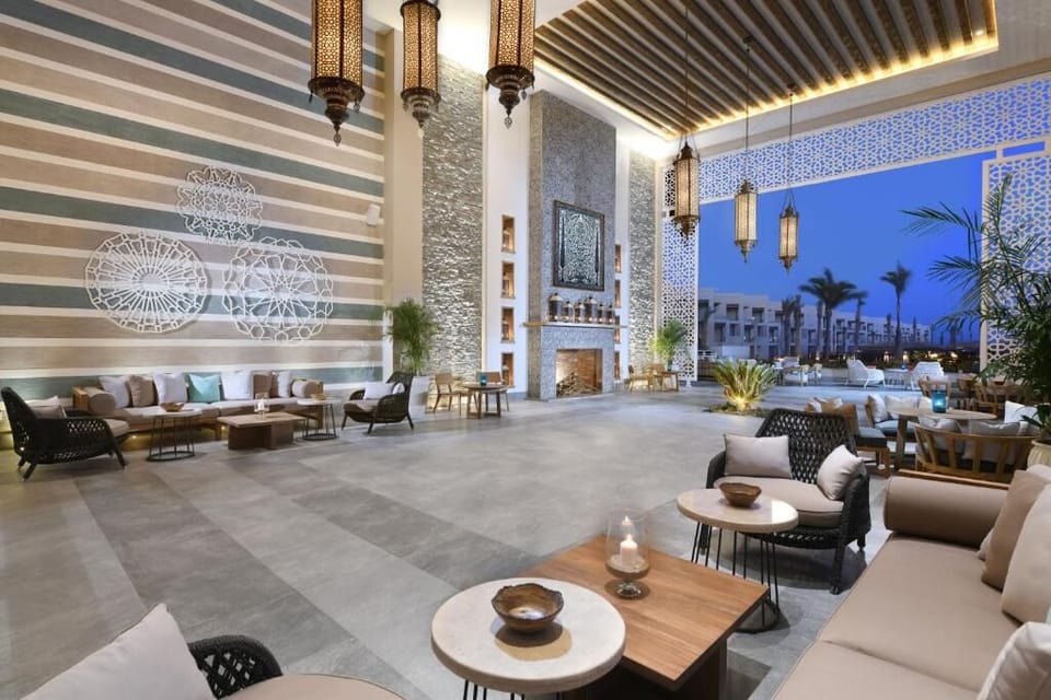 Unwind on plush seating under lantern-lit open-air charm.