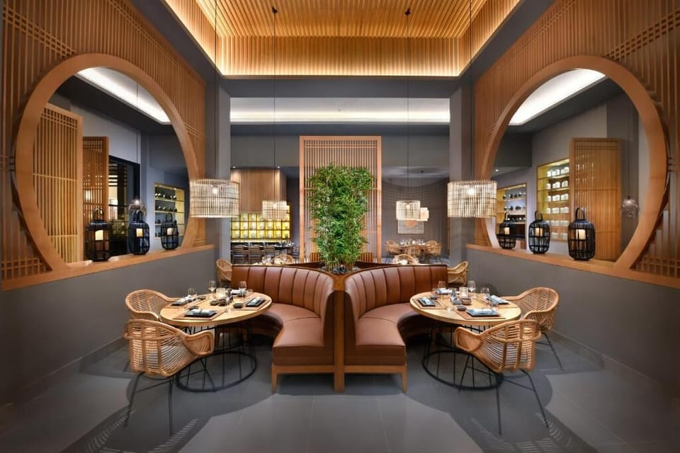 Share an intimate dinner in a chic, softly glowing booth.