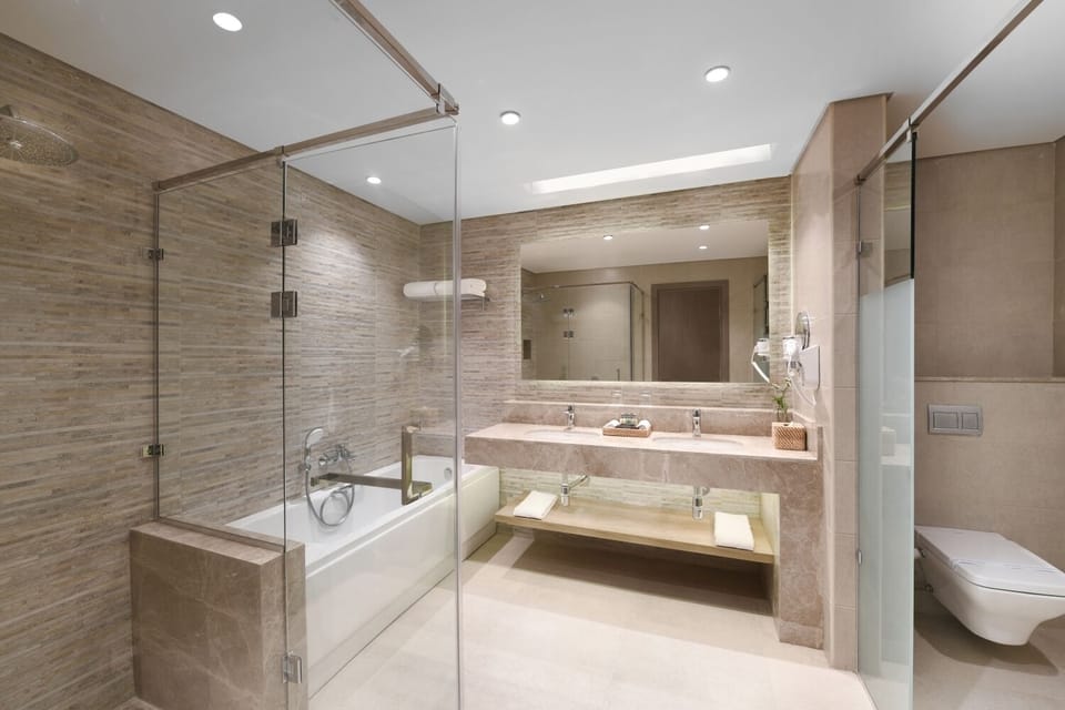 Refresh in a spa-like bath with glass shower and tub.