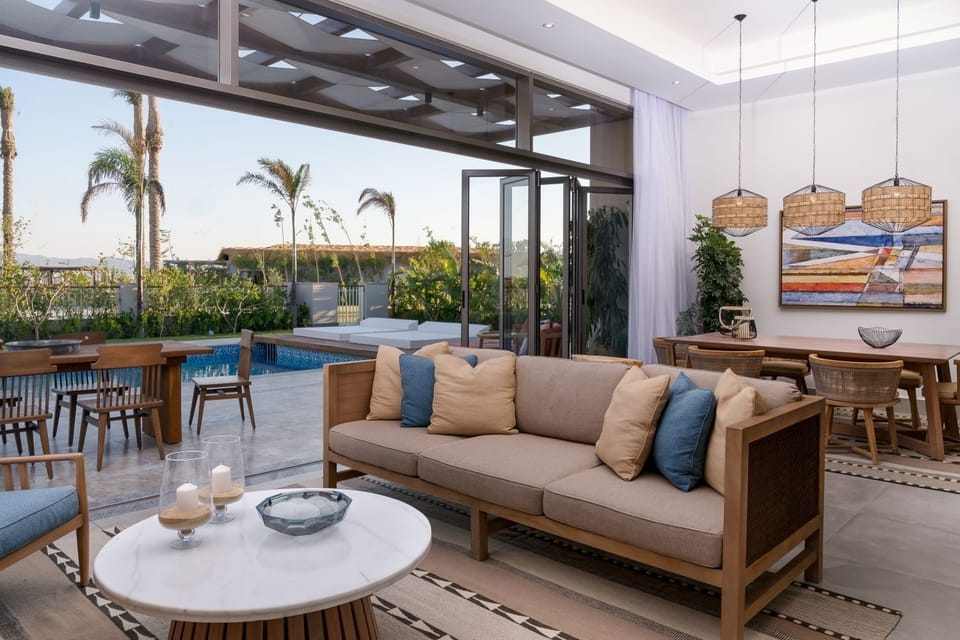 Unwind on plush seating as doors open to breezes.