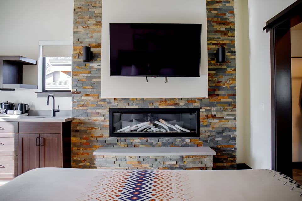 Kick back for movie nights by the fireplace glow.