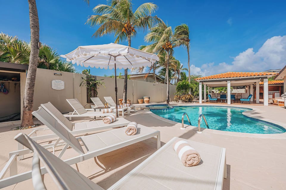 Poolside loungers with umbrellas for sunbathing and relaxation