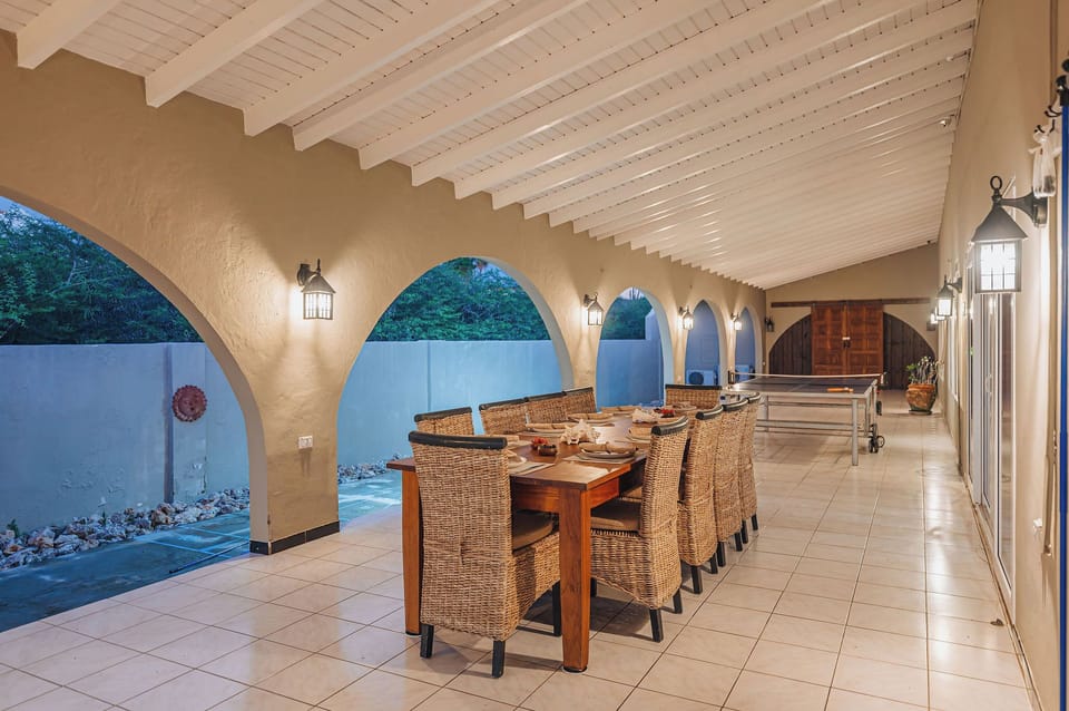 Covered outdoor dining area with long table, ideal for group meals
