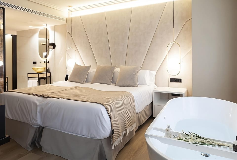 Unwind in plush bedding beside your private soaking tub.