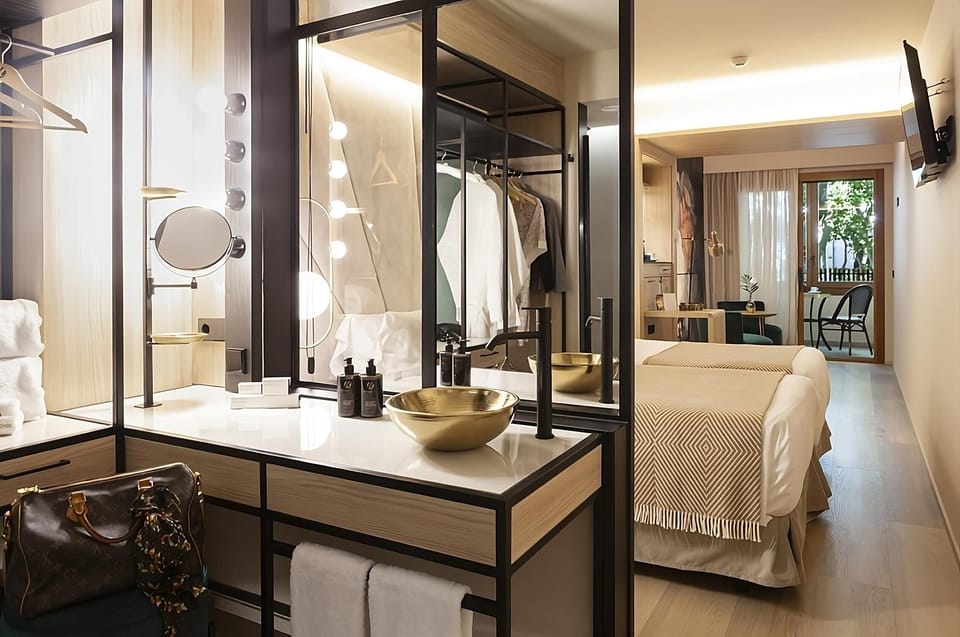 Step into a bright suite with balcony views and calm.