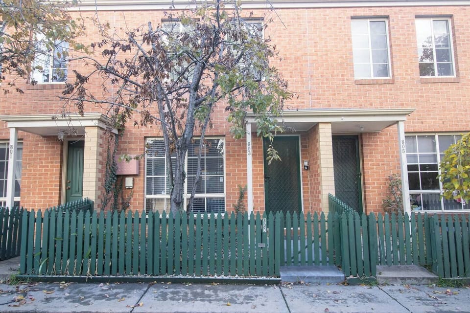 Charming Exterior: Enjoy the inviting vibe of this lovely brick façade with vibrant greenery!