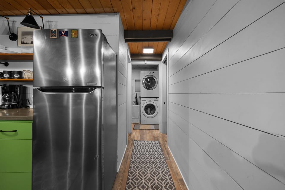Convenience meets comfort! This photo shows the well-appointed kitchen and the easy access to the in-unit laundry facilities, making your stay seamless and stress-free.
