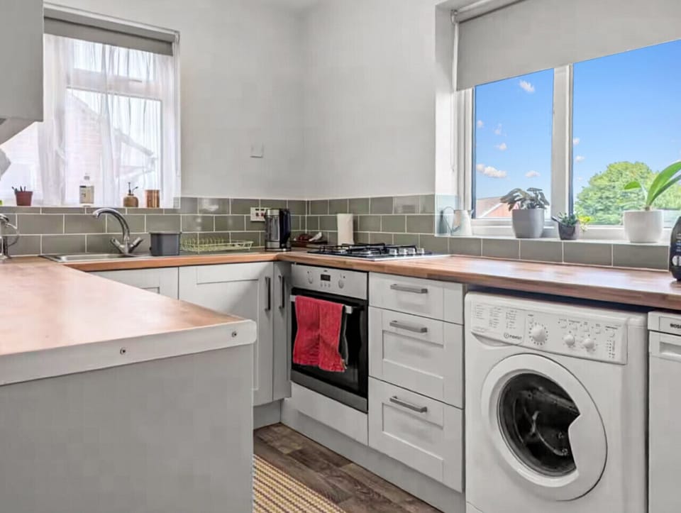 Kitchen view showing oven, hob and washing machine