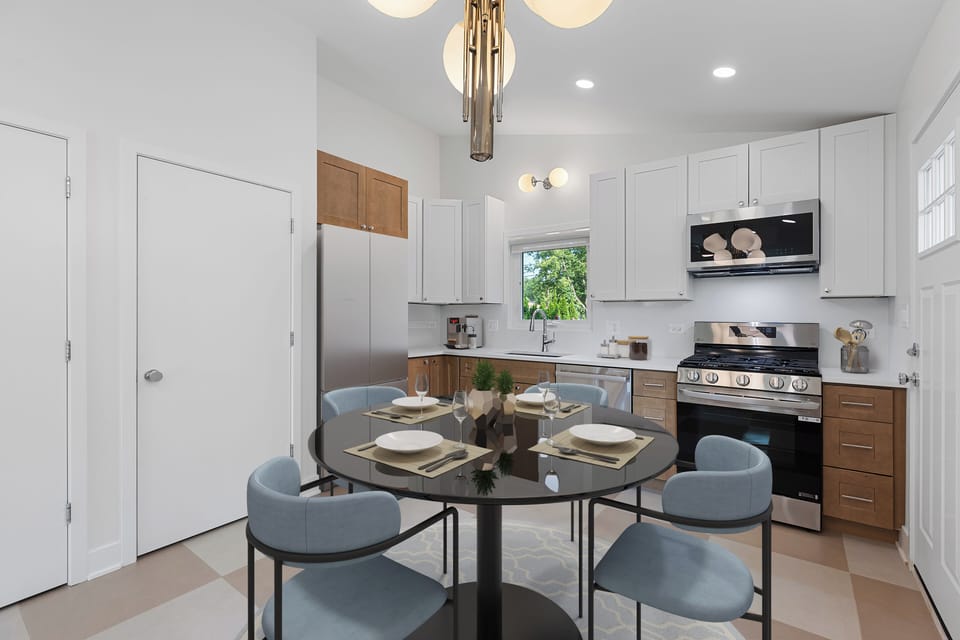 Open eat-in kitchen with quartz counters, new appliances, and breakfast bar.