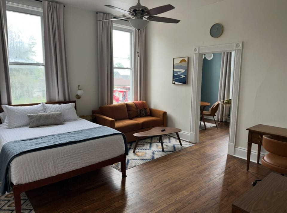 Main room with queen bed and living area with downtown views