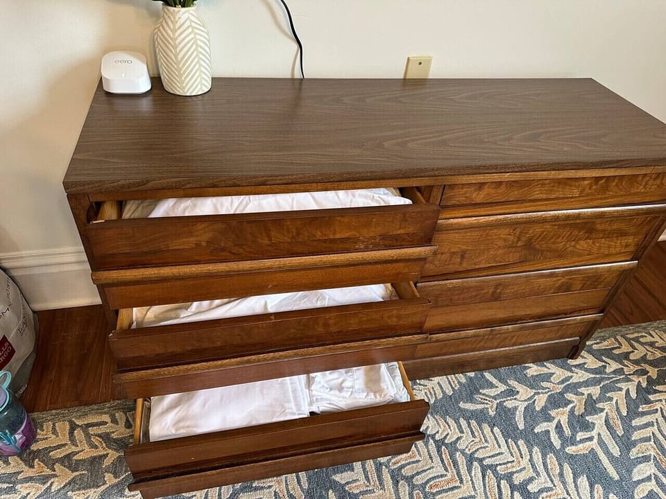 Extra pillows and bedding for sofa bed underneath TV