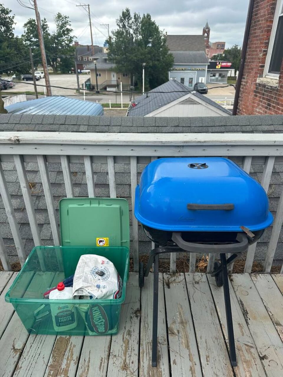 Charcoal grill and supplies on shared back deck