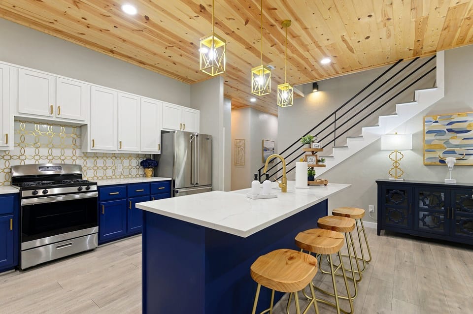 Spacious gourmet kitchen with large island, bar seating, and modern finishes