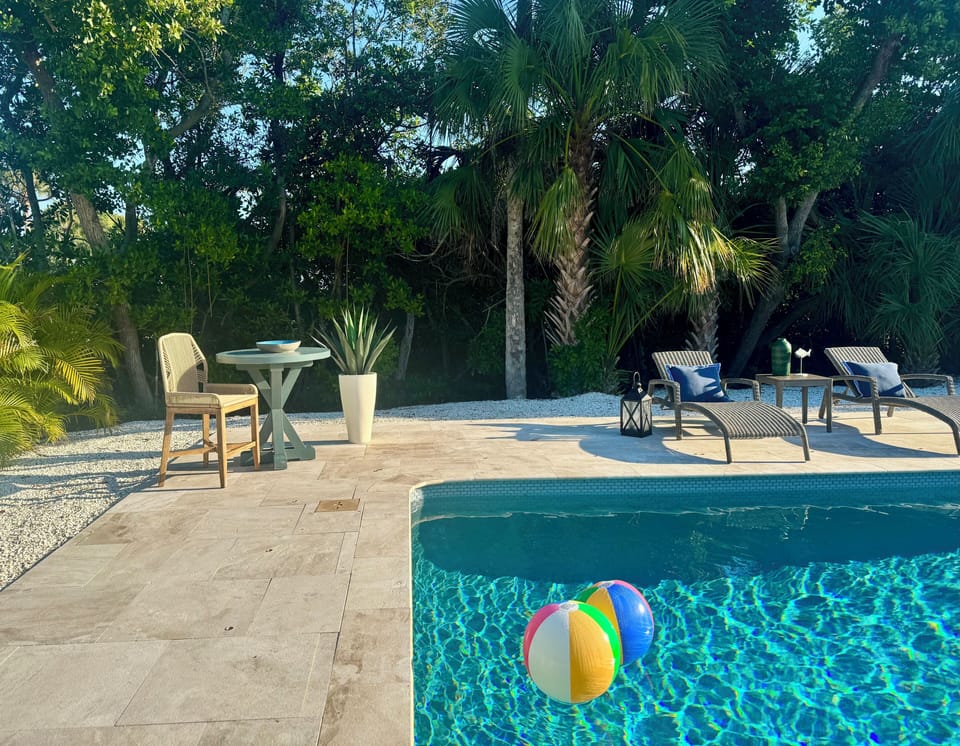 Refreshing pool surrounded by palm trees and privacy