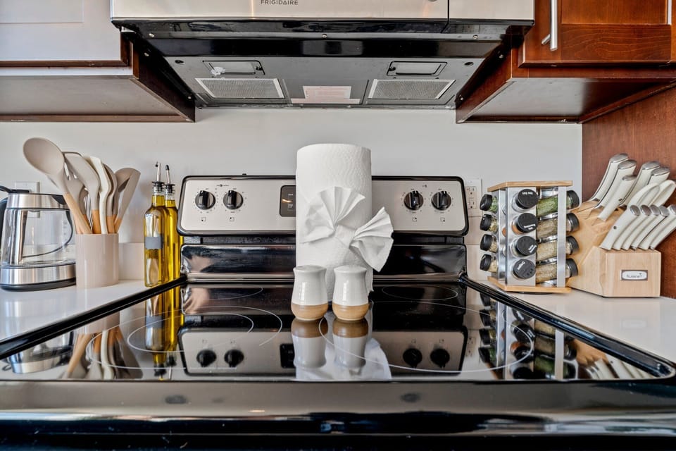 Spotless, modern stove and cookware ready for your cooking needs — from quick breakfasts to full dinners.