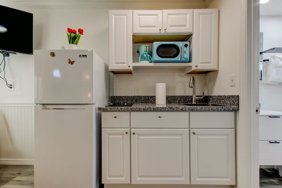 Kitchen with Full Fridge, Cooktop, Microwave, Coffee Pot & Toaster
