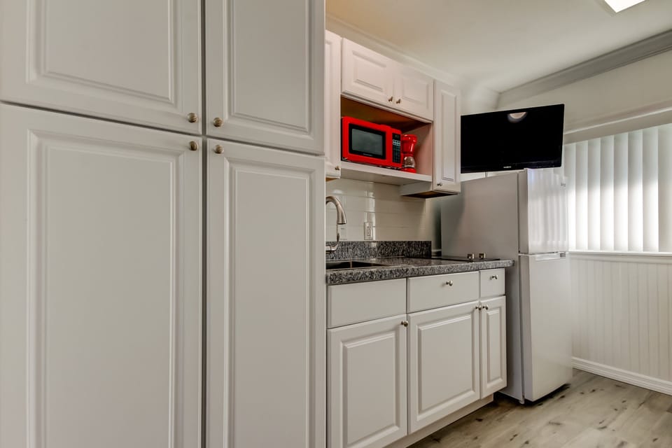 Kitchen with Full Fridge, Cooktop, Microwave, Coffee Pot & Toaster