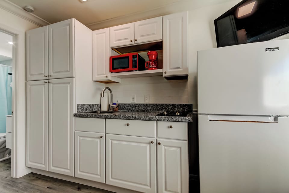 Kitchen with Full Fridge, Cooktop, Microwave, Coffee Pot & Toaster