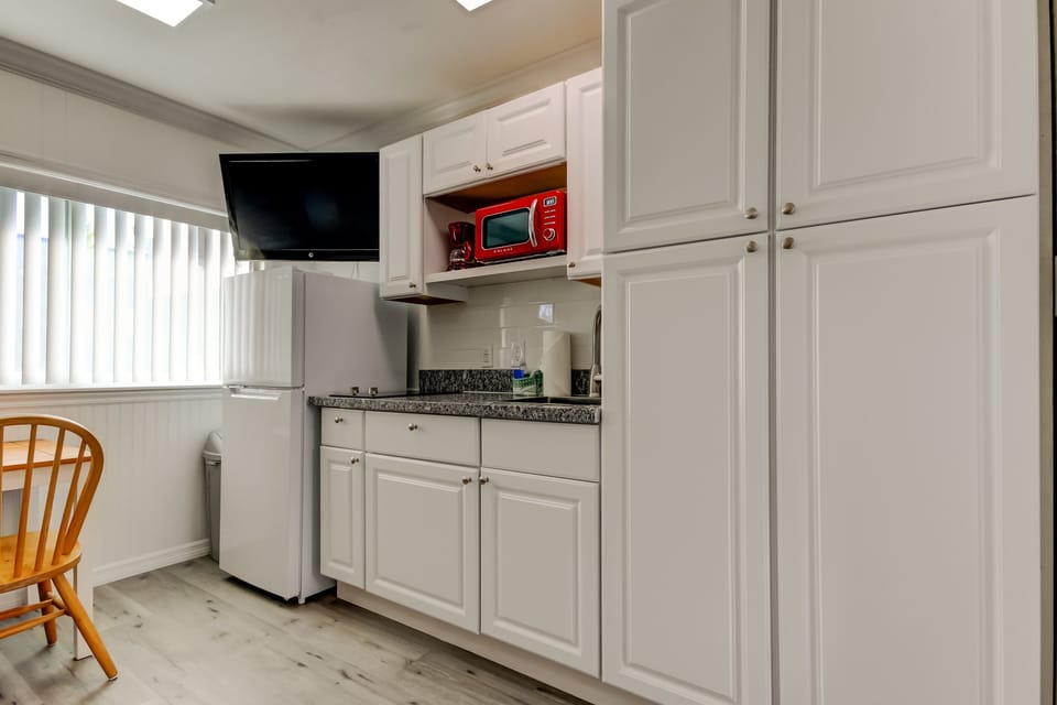 Kitchen with Full Fridge, Cooktop, Microwave, Coffee Pot & Toaster
