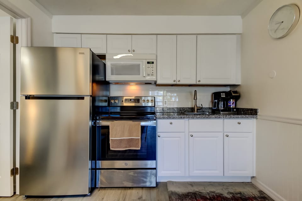 Kitchen with Full Fridge, Oven, Microwave, Coffee Pot & Toaster