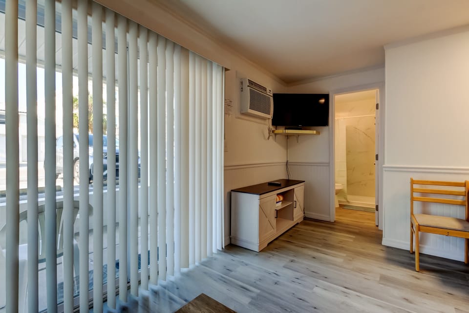 Living area with TV & Sliding glass doors
