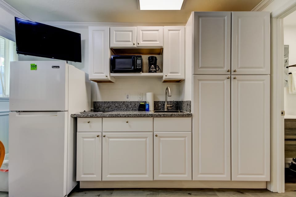 Kitchen with Full Fridge, Cooktop, Microwave, Coffee Pot & Toaster