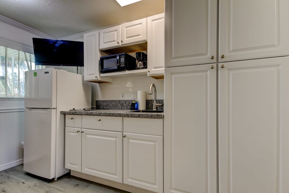 Kitchen with Full Fridge, Cooktop, Microwave, Coffee Pot & Toaster